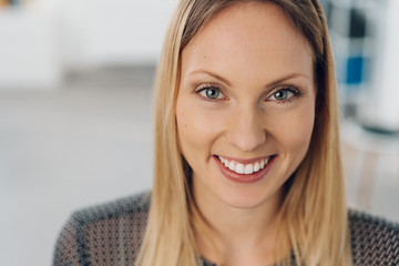 Close up head shot of a smiling happy blond woman