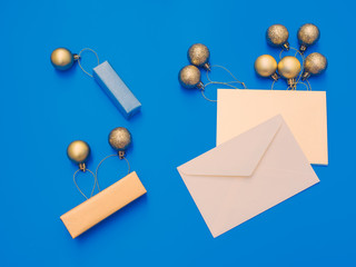minimal flat lay by balloon flew away concept for christmas and new year event with greeting card , small gift box and group of shiny gold ball or balloon arrange on table 