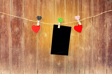 Handmade two wood hearts hanging and card on cloth line or