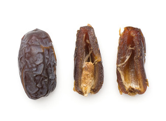 Date fruits Medjool variety top view isolated on white background one whole two halves one with a seed compare.