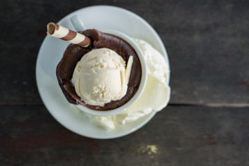 chocolate lava cake and vanilla ice cream. dessert in white cup