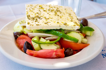 Traditional Greek salad served in Greek tavern. Naxos island. Greece.