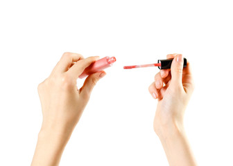 Hands holding pink lip gloss on white background. Closeup