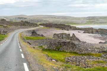 Rocky cliffs on the coast of the Barents Sea along the Varanger Tourist Route