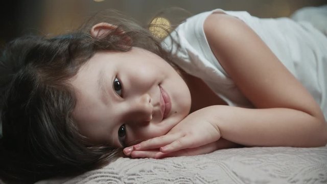 little 5-6 years old Asian girl portrait dreams in her room