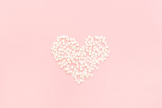 Valentine's Day composition. Heart on pale pink background. Flat lay, top view Love concept.