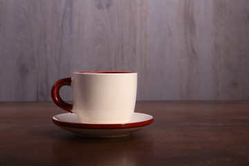 A cup of espresso coffee on a dark wooden background