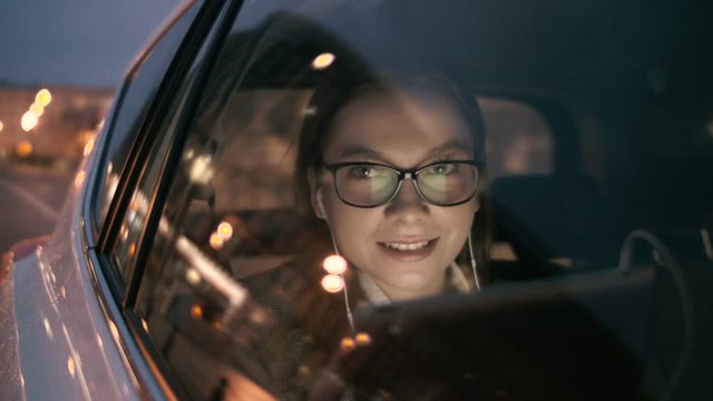Young Woman Having a Nice Skype Call in the Moving Car