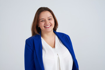 Smiling woman in official wear posing at camera