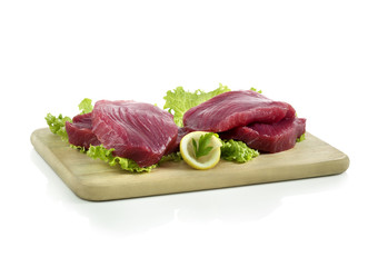 raw fresh tuna on a wood chopping board