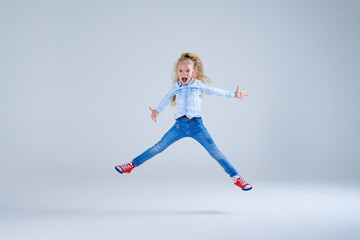 Laughing joyful girl jumping with outstretched hand