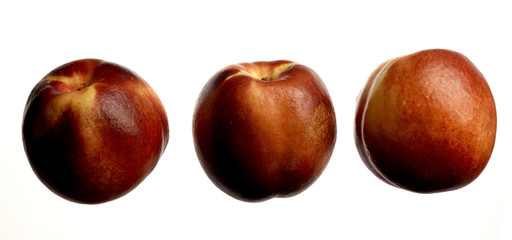 three nectarine peaches on white background