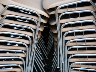 stack of plastic chairs in outdoor cafe