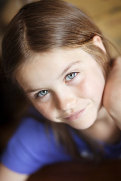 Portrait of smiling girl with blue eyes and brown hair