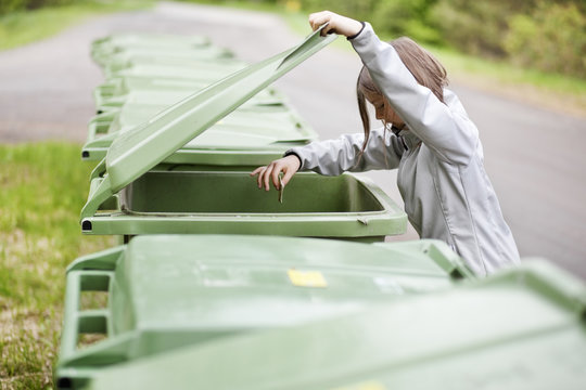 Girl throwing out garbage into bin