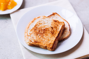 Toast bread on white plate.