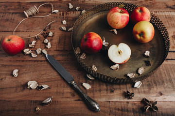 Apples on metalic tray, wood table
