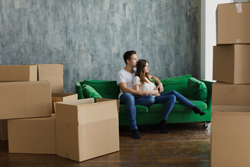 Young happy millennial couple students move into their first new owners home. Simple white background of urban apartment