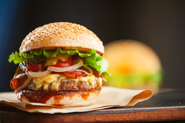 mouth-watering delicious homemade burger used to chop beef on the wooden table.