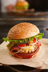 mouth-watering delicious homemade burger used to chop beef on the wooden table.