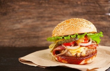 mouth-watering delicious homemade burger used to chop beef on the wooden table.