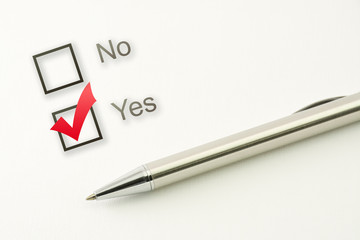 questionnaire: yes no choice, marked check box with a pen on paper background. Approval concept