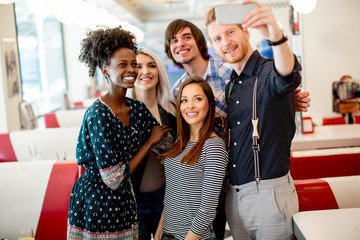 Group of young people taking selfie with mobile phone