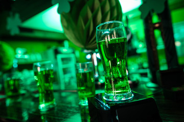 A glass of beer is on the bar.