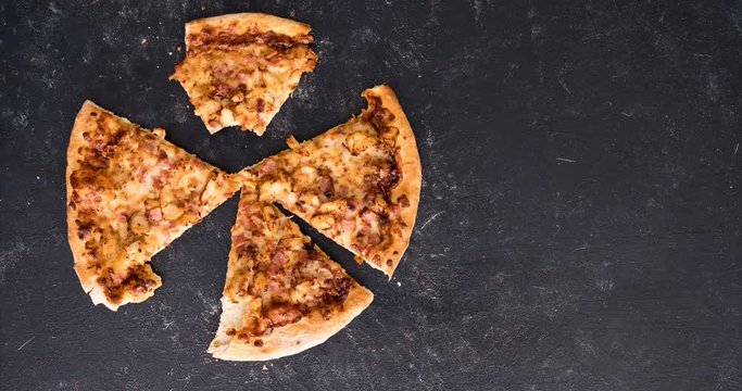 Stop motion animation of eating a pizza on dark background