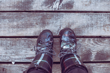 Women boots on wooden pier