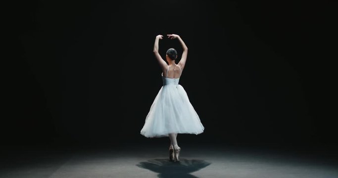 beautiful Asian girl ballet dancer dancing on black background slow motion