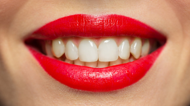 lips or mouth of smiling woman with red lipstick