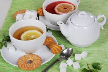 grapefruit and lemon tea with sweet cookies and sugar cubes