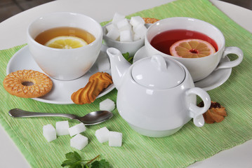grapefruit and lemon tea with sweet cookies and sugar cubes