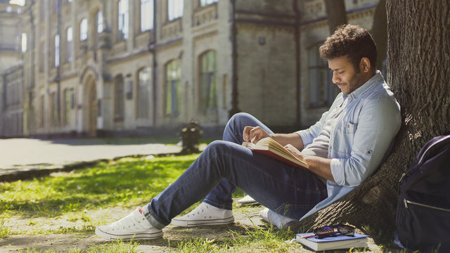 Mixed-race Guy Sitting Under Tree In Park, Reading Book, Leisure Time, Hobby