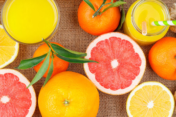 Different fruits and glass with fresh orange juice