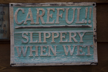 Fototapeta premium CAREFUL! SILPPERY WHEN WET SIGN