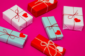 Happy Valentineы day composition: bright gift boxes with red heart on pink background, photo template. Top View