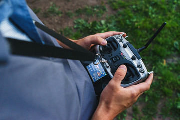 man holds a remote control during the flight control of a sports drones