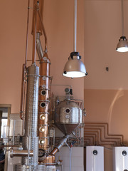 Fototapeta na wymiar alembic still for making alcohol inside distillery, destilling spirits