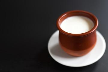 Sour  cream or natural  Cottage cheese curd  in traditional ceramic bowl on dark  background. Traditional Cuajada yogurt cream