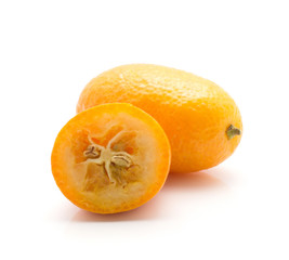 Kumquat one whole and sliced half isolated on white background.