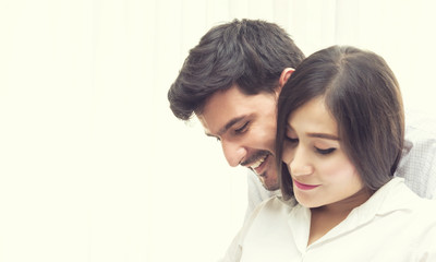 Handsome Man Smiling and Hugging His Pregnant Wife with Love - Family Concept