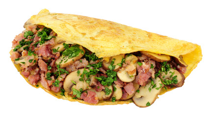 Mushroom and bacon omelette folded in half isolated on a white background