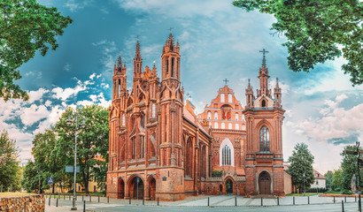 Fototapeta na wymiar Vilnius, Lithuania. Panoramic View Of Roman Catholic Church Of St. Anne And Church Of St. Francis And St. Bernard In Old Town In Summer Sunny Day.