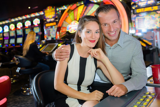 Portrait of couple at casino machine