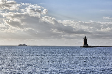 Ferry approaching lighthouse on bay © francis