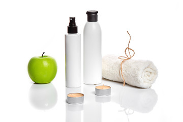 Natural spa beauty treatment cleansing products with apple on white background.
