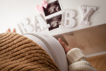 Women looking at ultrasound picture of her future daughter.