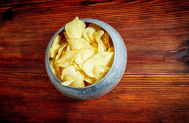 Fried potatoes with salt,  spices on a wooden Board on brown background with copy space. The view from the top